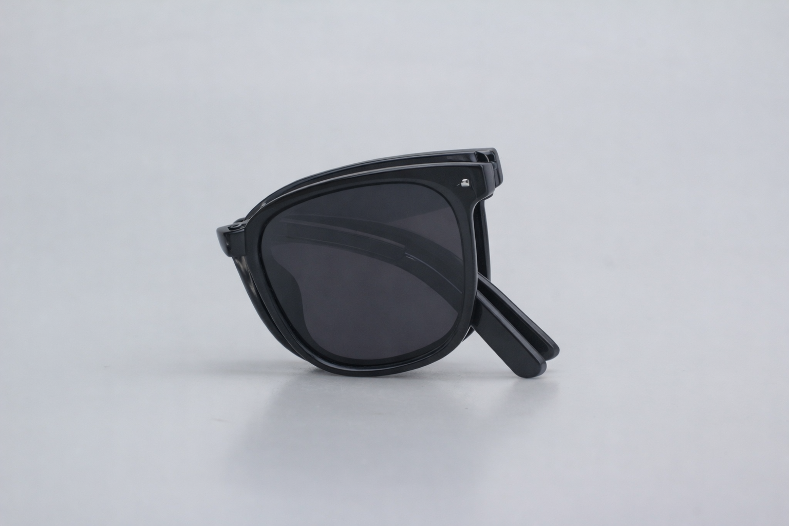 Black sunglasses on a light gray background