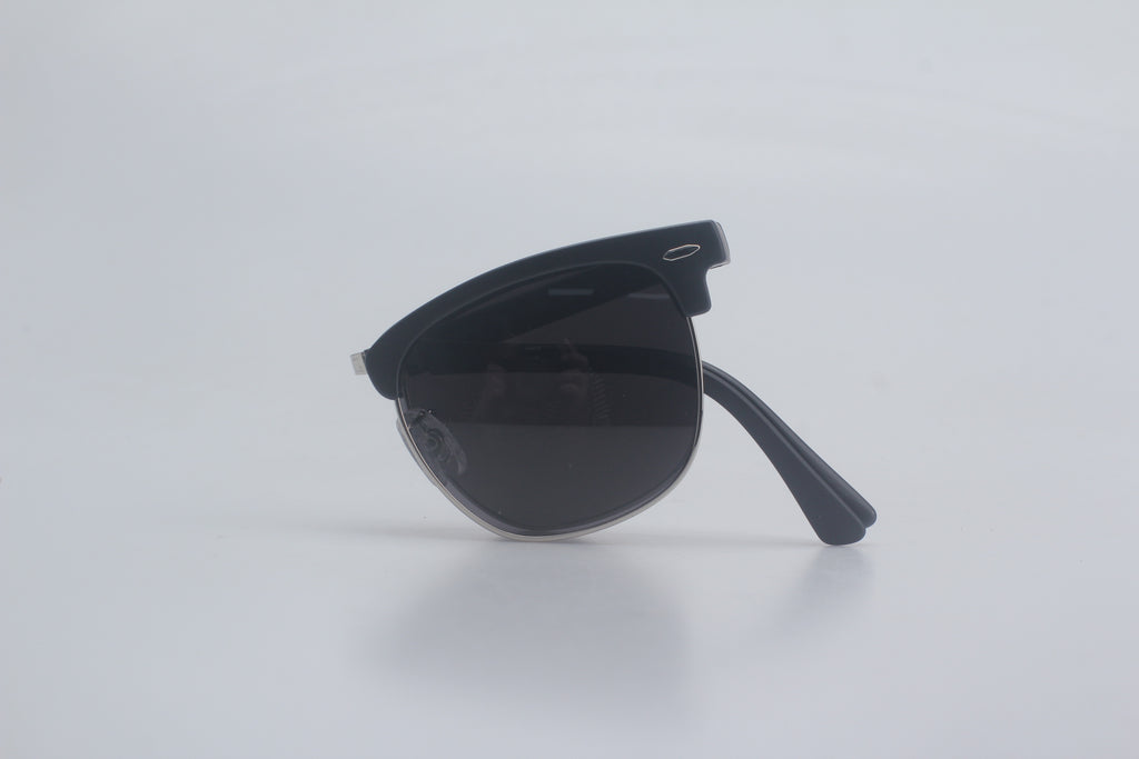 Classic black Clubmaster sunglasses featuring durable TR90 frames, polarized smoke lenses for glare reduction, and adjustable hinges, neatly folded against a minimalist white surface for men's and women's premium eyewear assortment, stylish sun blockers, full UV ray defense eyewear, timeless vintage vibes shades, upscale optic fashion items, beach-ready eye safeguard gear.
